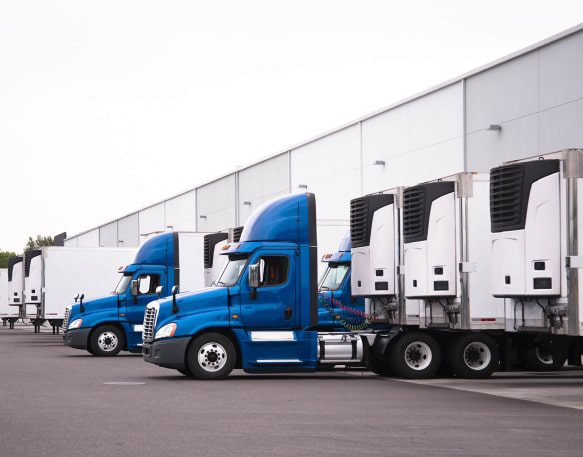 DAT Equipment Trucks At Loading Dock Reefer