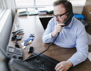 DAT People Broker On Phone Office