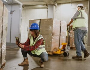 DAT People Shipper In Warehouse Examining