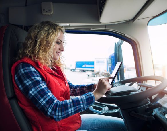 https://www.dat.com/resources/wp-content/uploads/2023/06/a-truck-driver-uses-her-truck-driver-app.jpg