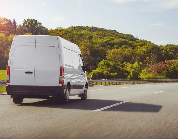 A Carrier Drives A Cargo Van Down A Highway To Deliver Loads Min