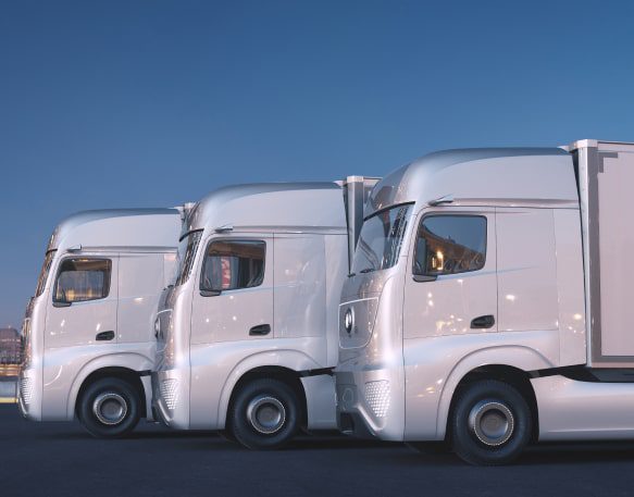 Three Self Driving Trucks Wait In A Line Min