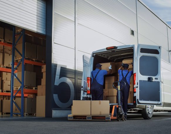 Two People Load A Cargo Van Min