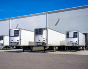 Row of temperature controlled trucking trailers.