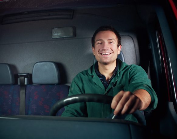 A happy truck driver delivers cargo.