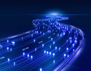 A luminous blue light trail arcs across a dark backdrop-emphasizing its vividness in the surrounding darkness.