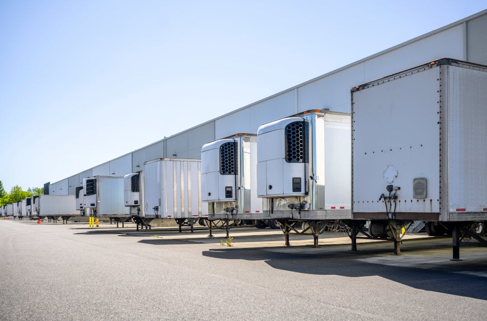 Truck trailers standing in a parking lot.