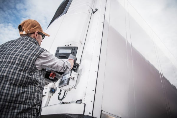 A trucker checks his reefer.