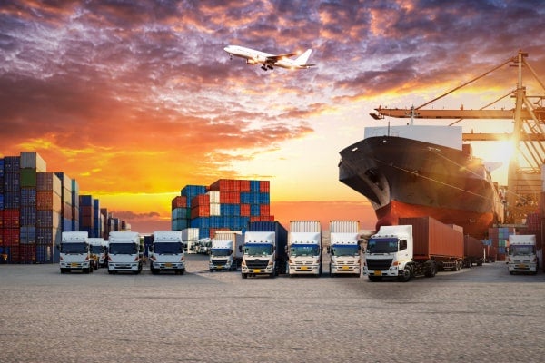 Image of different elements of the supply chain including trucks, freight crates, ships, and a plane.