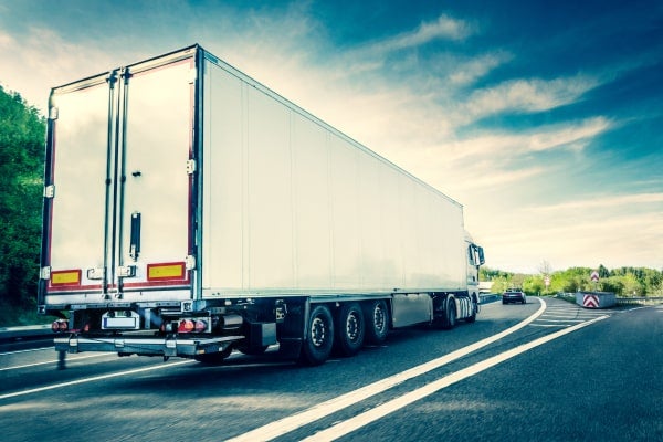Commercial truck driving down the highway.