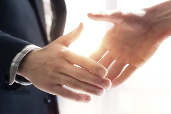 Direct shipper and carrier shaking hands.
